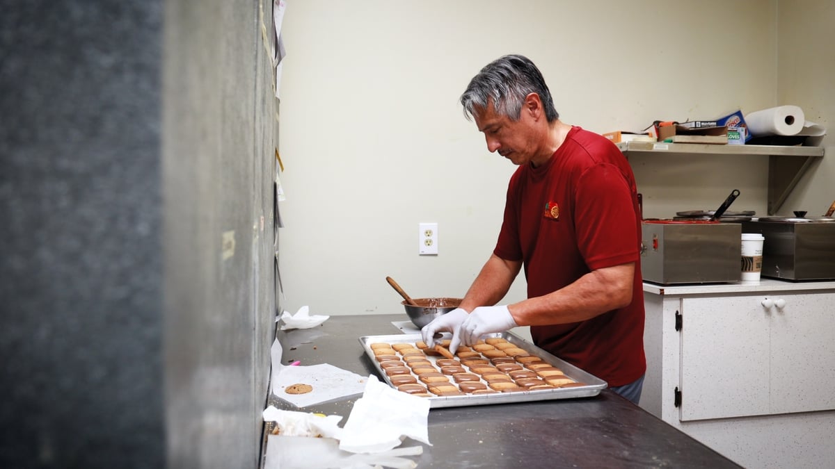 Person handling cookies in a kitchen