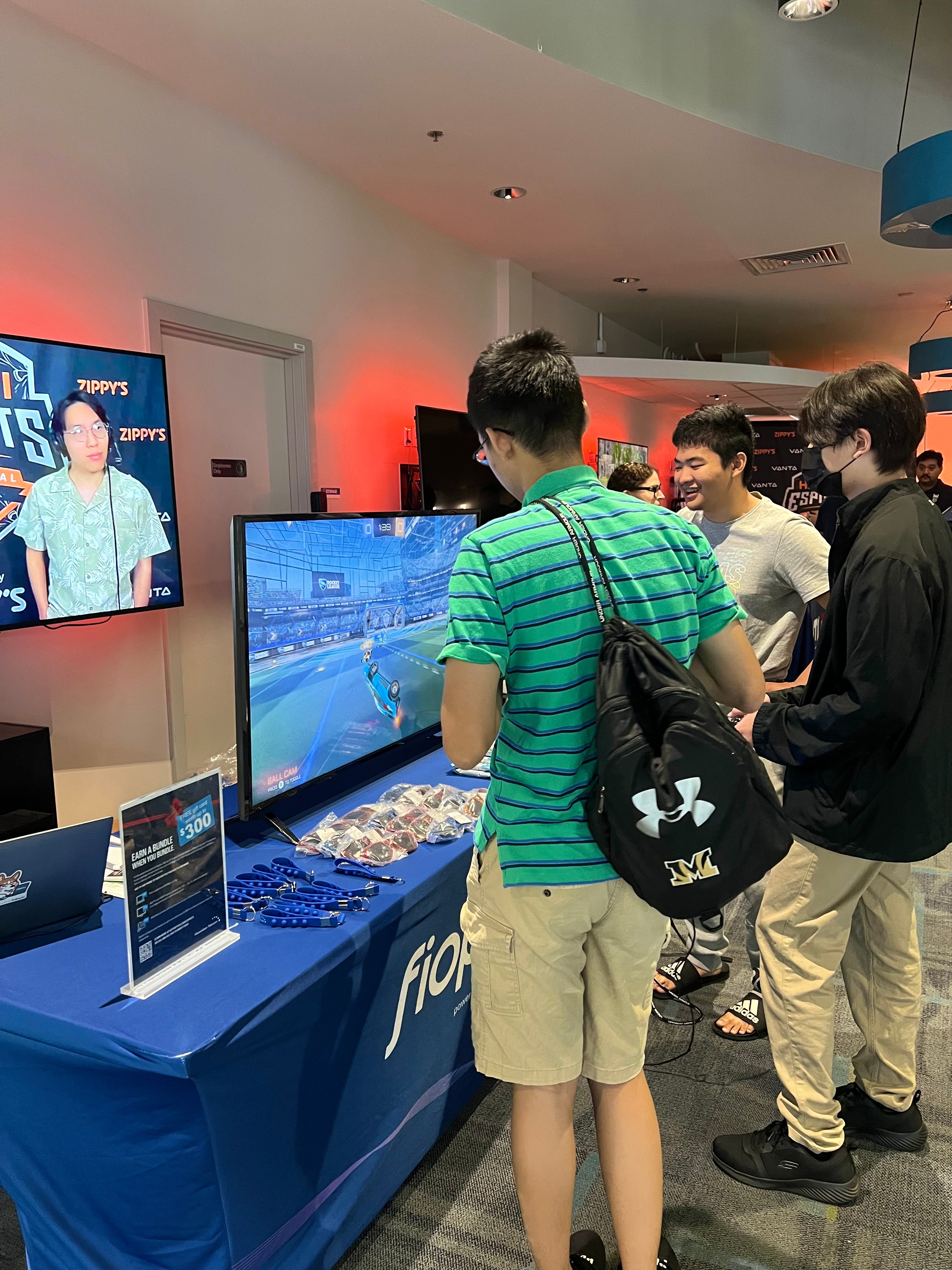 Attendees playing Rocket League at the Hawaiian Telcom table